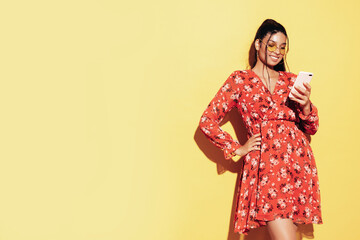 Young beautiful smiling female in trendy summer dress clothes. Sexy carefree woman posing near...