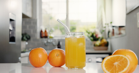 Nutrition, juice or glass in kitchen with orange, antioxidant or vitamin benefit in morning drink. Organic, hydration or fruit in house with detox diet, gut health or digestion in breakfast beverage.