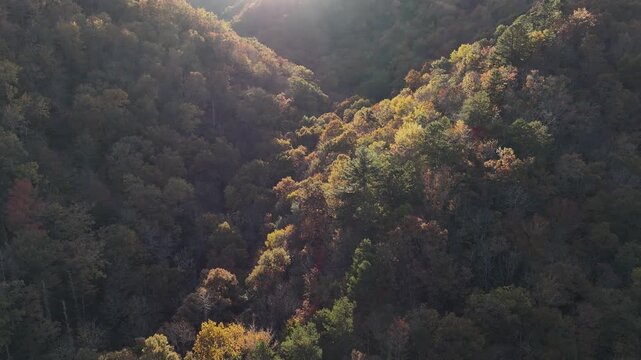 Drone view of sunsetting over hills and mountains