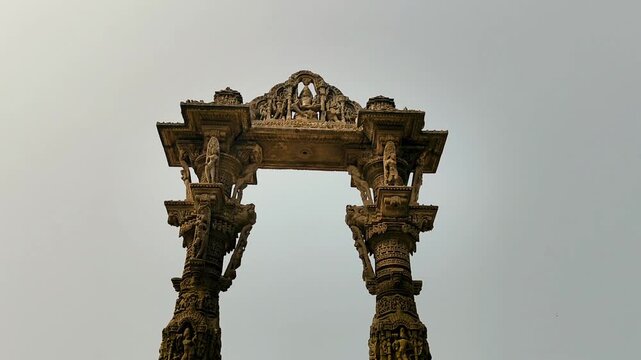 Kirti Toran in Vadnagar, Gujarat, India showing ancient carved stone pillars and heritage architecture representing rich Indian culture and history under clear sky.