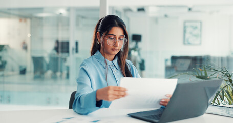 Laptop, businesswoman and paperwork review in office for stocks analysis, financial report and IPS. Portfolio manager, person and tech with documents at desk for tax strategy and tracking performance