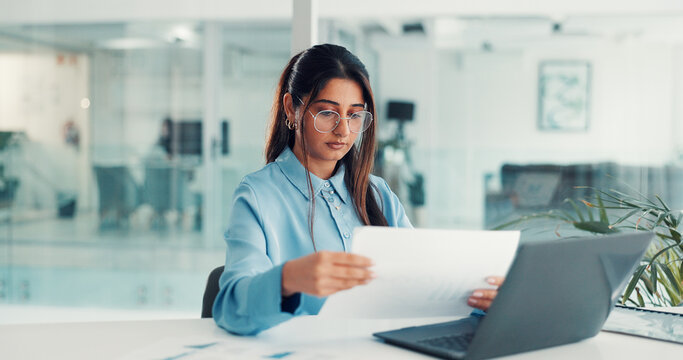 Laptop, businesswoman and paperwork review in office for stocks analysis, financial report and IPS. Portfolio manager, person and tech with documents at desk for tax strategy and tracking performance