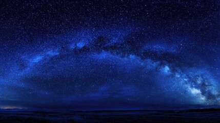 Fototapeta premium Starry blue night sky panorama showing the universe and nebula within a tranquil dark canvas