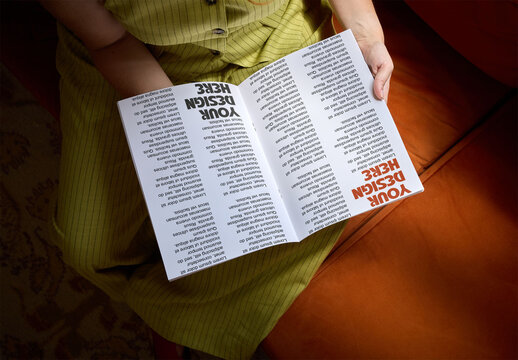 Mockup of an open book held in a woman's lap
