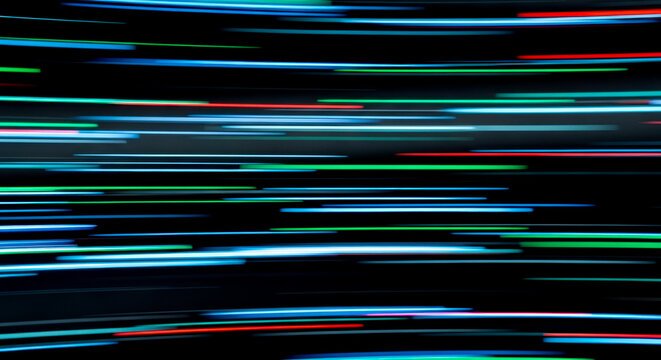 Abstract background of colorful neon light trails on black for concept of speed, technology, or motion