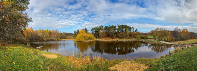 Fototapeta premium Serene Pond Surrounded by Autumn Colors