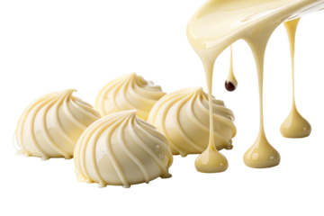 Melted white chocolate drizzling over swirled creamy sweets