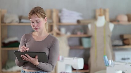 Female dressmaker working on digital sketch of dress in workshop - Powered by Adobe