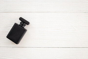 Stylish men perfume in a black bottle top view. Male fragrance and cosmetic concept