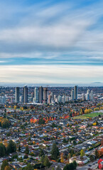 Obraz premium City Skyline Over a Fall Suburban Neighborhood in Burnaby, Greater Vancouver, BC, Canada
