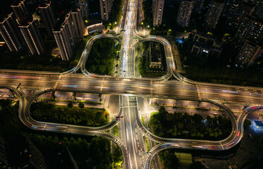 Aerial view of illuminated highway interchange with light trails at night in city of Hangzhou, China