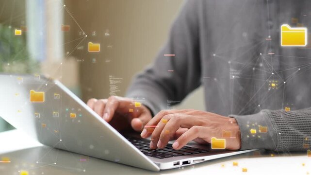Close-up of hands typing on a laptop with floating digital file icons, representing cloud storage, data management, and online information security. technology cloud computing. - Powered by Adobe
