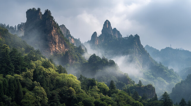 A scenic view of jagged mountain peaks shrouded in mist and lush green vegetation - Powered by Adobe