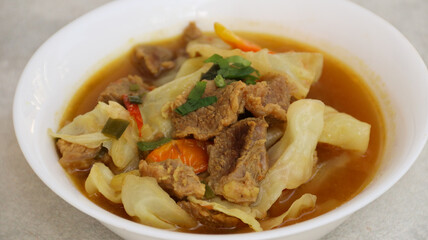 Tongseng Sapi or Beef Tongseng, Indonesian Traditional food made of beef with curry like soup and sweet soy sauce and various spices. white background
