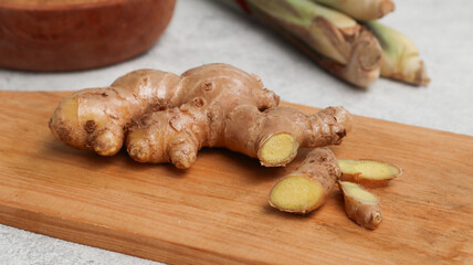 Ginger roots on wooden cutting board	