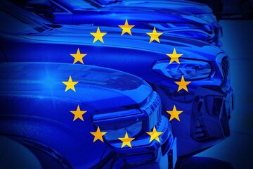 Close up cars with the European flag as background.