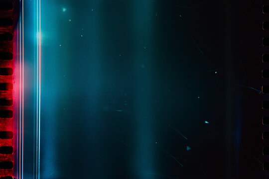 Scratched film strip with teal tones, perfect for vintage projects, movie concepts, retro designs, or artistic backgrounds. Great filmic aesthetic.