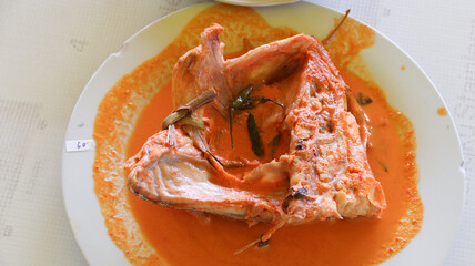 snapper curry fish head (gulai kepala ikan kakap) from padang, west sumatera, indonesia