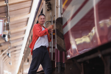 Man smiling while boarding train at station platform
