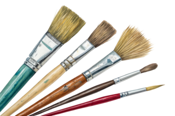 Assortment of artist paint brushes laid out on white paper