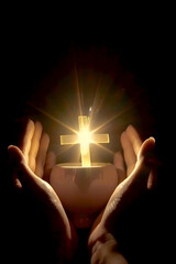 Hands cradling a glowing cross emanating divine light in darkness