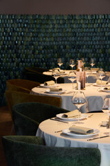 Elegant dining setup in a stylish restaurant with green decor