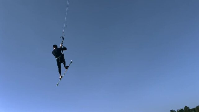 Kitesurfer Jumping High Against the Clear Sky