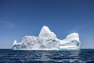 White Iceberg on Wavy Blue Water