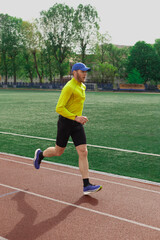 Fototapeta premium Man running at the city stadium