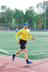 Obraz premium Athlete training and running on stadium