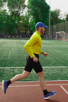 Man running along football stadium