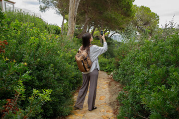 Woman taking pictures of nature on smartphone on Mallorca island