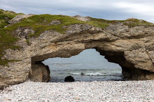Natural Sea Arch Over a Pebble Beach