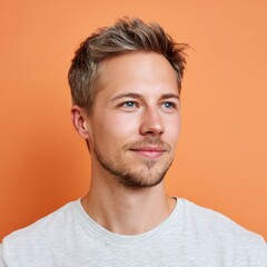 Fototapeta premium Smiling young Hungarian man with positive expression against orange background