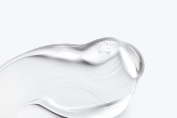 A close-up of a cosmetic smear of creamy gel texture on a light background