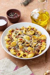 Pasta with bolognese sauce and cheese. Italian cuisine. Traditional recipe.