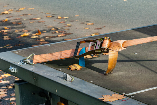 Secure strap on a flatbed trailer during autumn season
