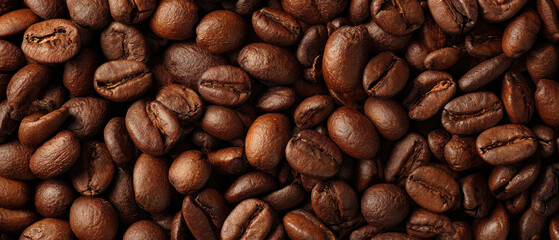 Obraz premium Top-Down View of Lots of Roasting Coffee Beans in Rich Brown Tones with Detailed Texture