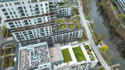 Modern apartments with rooftop grass and plants