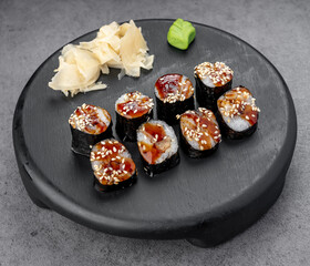 Eel maki with teriyaki and sesame. Compact seaweed rolls feature eel in glossy teriyaki, sprinkled with sesame for balance.