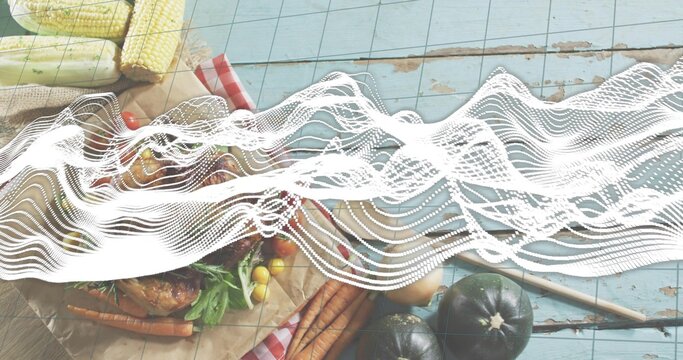 Displaying rustic spread with roasted bird, carrots, corn, tomatoes on blue planks, waveform