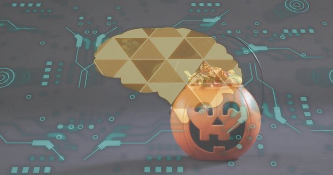 Displaying orange pumpkin candy holder on gray table showing gold candies, brain motif, teal HUD