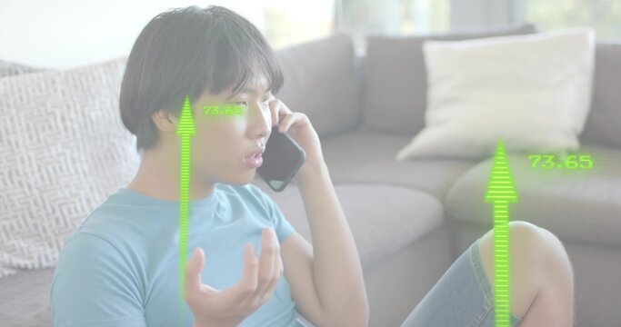 Talking Asian man on phone at home in blue-tee denim-shorts showing green AR-73
