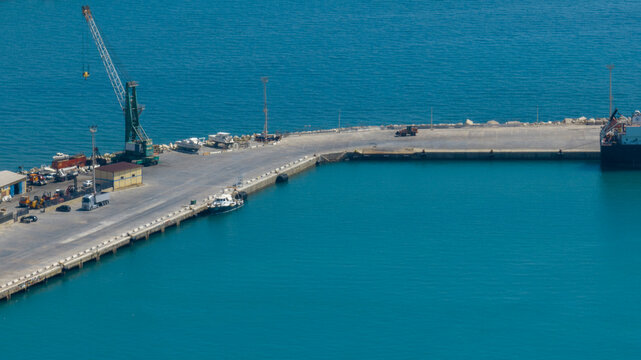 Aerial view of a paved pier at an industrial port.