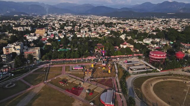 Aerial shot of the Ravan statue during the Dussehra or Vijayadashami Festival in Pared Ground, Dehradun, with traffic passing by alongside.