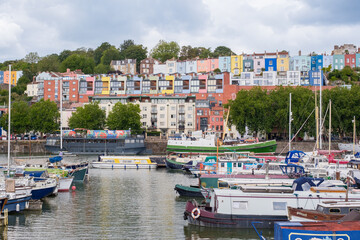 Bristol UK: 28th July 2025:  Bristol Harbourside features an inviting scene with boats docked in the water and bright buildings lining the shore