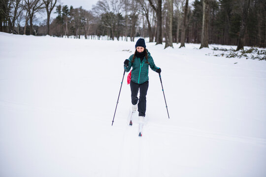 Woman happily cross country skiing in winter