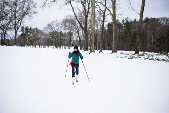 Woman happily cross country skiing in winter