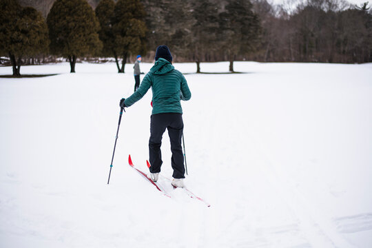 Woman happily cross country skiing in winter