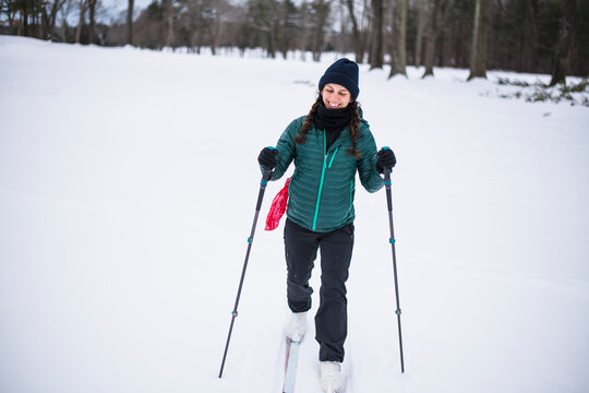 Woman happily cross country skiing in winter